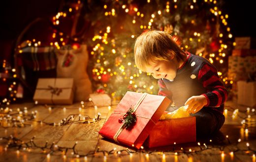 Little boy opening gift online
