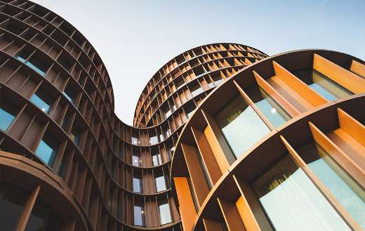 Architecture round towers yellow shiny metal and glass