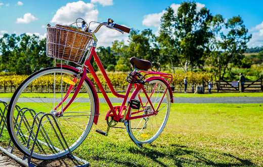 Red cruiser parked on metal bike stand online
