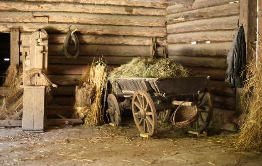 Wooden cart with hay in old barn online