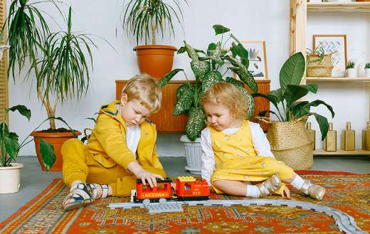 Adorable kids playing toy train