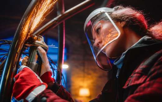 Close up woman using angle grinder online