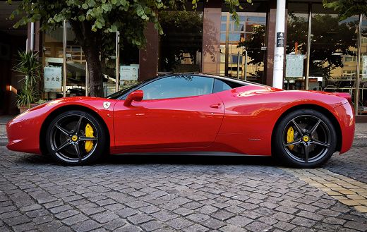 Red ferrari parked on the street
