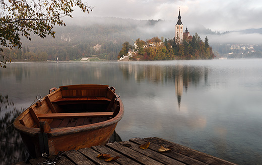 brown-wooden-boat-floating-on-body-of-water