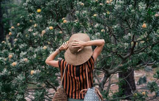Woman standing near trees online