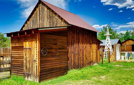Brown wooden barn under blue sky