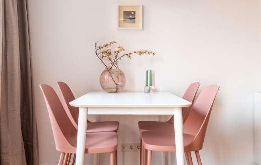 Dining able and pink chairs in light dining room