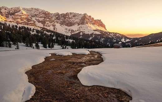 Lake almost covered by snow