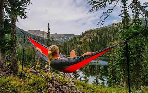 Woman relaxing hammock online
