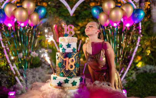 Birthday woman blowing candles