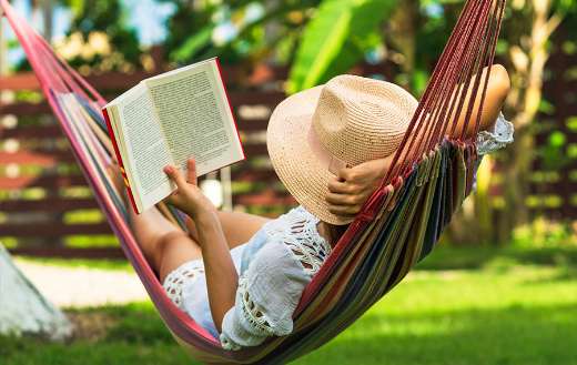 Woman reading book in hammock puzzle