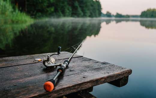 Fishing rod spider reel on the bank