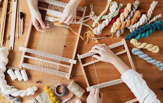 Two person's hands weaving