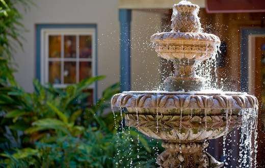 Two tiered garden fountain flowing with water