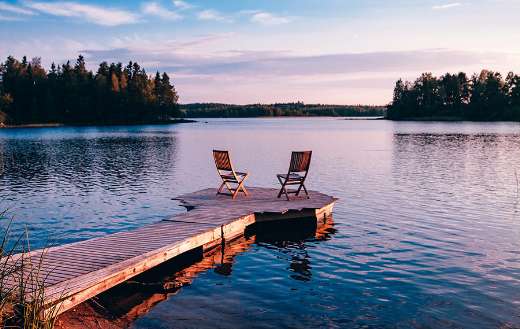 Two wooden chairs on wooden pier