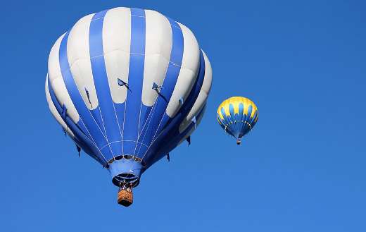 Two blue and yellow hot air balloon
