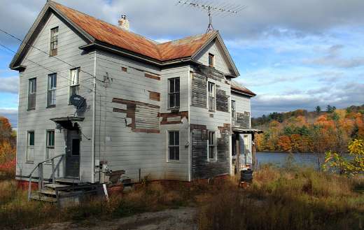 Facade white abandoned house