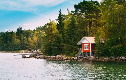 Red small finnish wooden log cabin