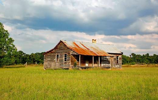 Abandoned house middle green open field