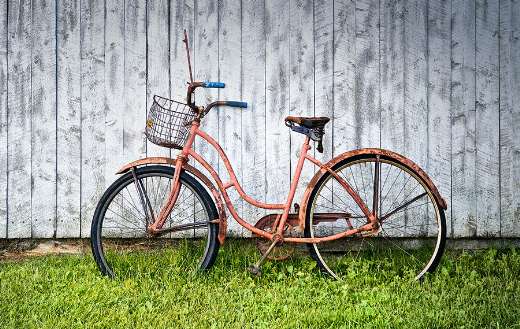 Old pink bicycle parked online