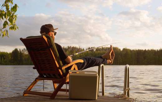 Man fishing from wooden pier