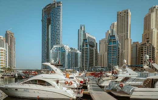 White yacht on dock near building Dubai