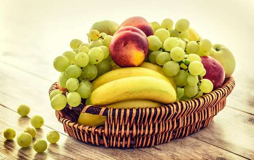 Several fruits in brown wicker basket