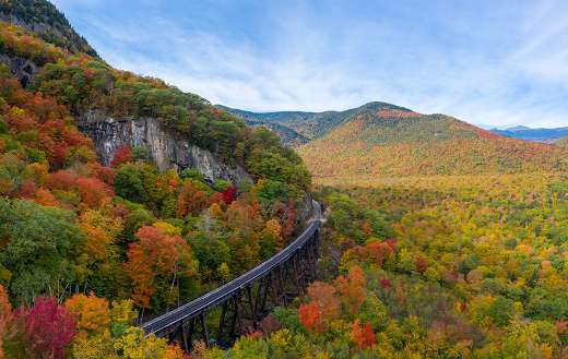 New Hampshire with train track trestle curving around mountainside