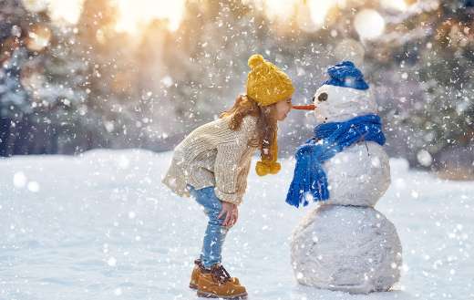 Girl paying with a snowman