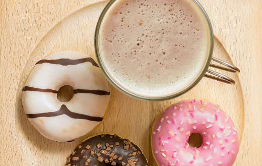 coffee and three donuts wooden plate
