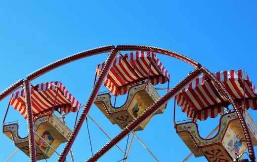 Carousel fair ferris wheel under blue sky