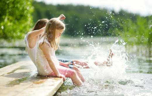 Summer times kids playing water lake