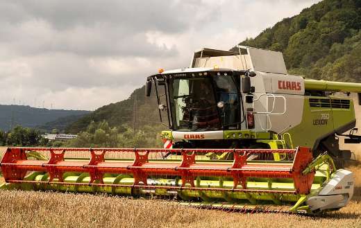 Combine harvester in field
