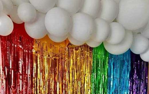 Colorful tinsel curtain with white balloons