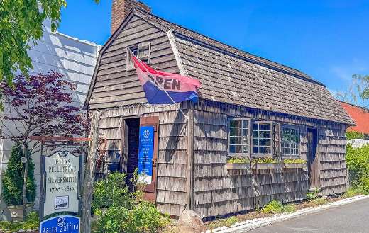 Log cabin building open flag