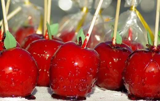 Bright red shiny apples on sticks