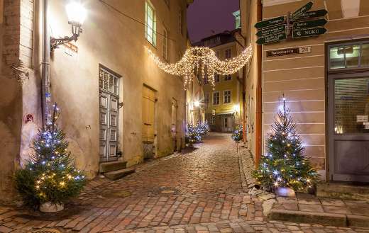 Cozy narrow cobblestone street Tallinn Estonia with Christmas decorations