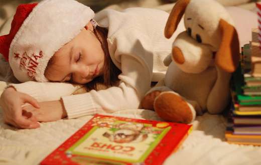 Girl in a Christmas hat sleeping