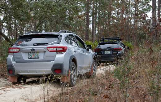 Two subaru crosstrek vehicles on a dirt road