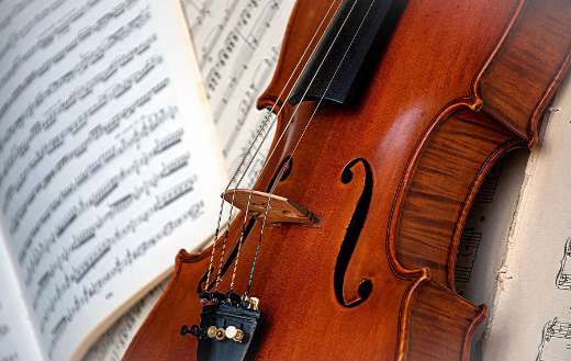 Violin lying on open sheet