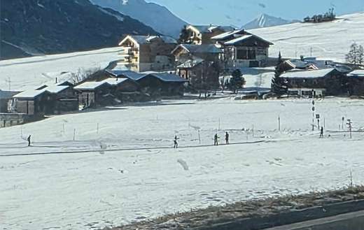 Snow covered mountain landscape with several chalet style building