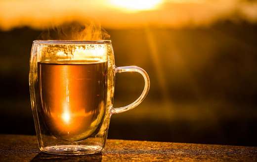 Steaming cup of tea in a double walled glass